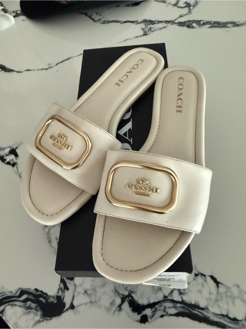 Coach Cream Slide Sandals with Gold Buckle Accent